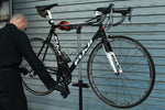 Technician using the LTR Bike Repair Stand during a service on road bike.